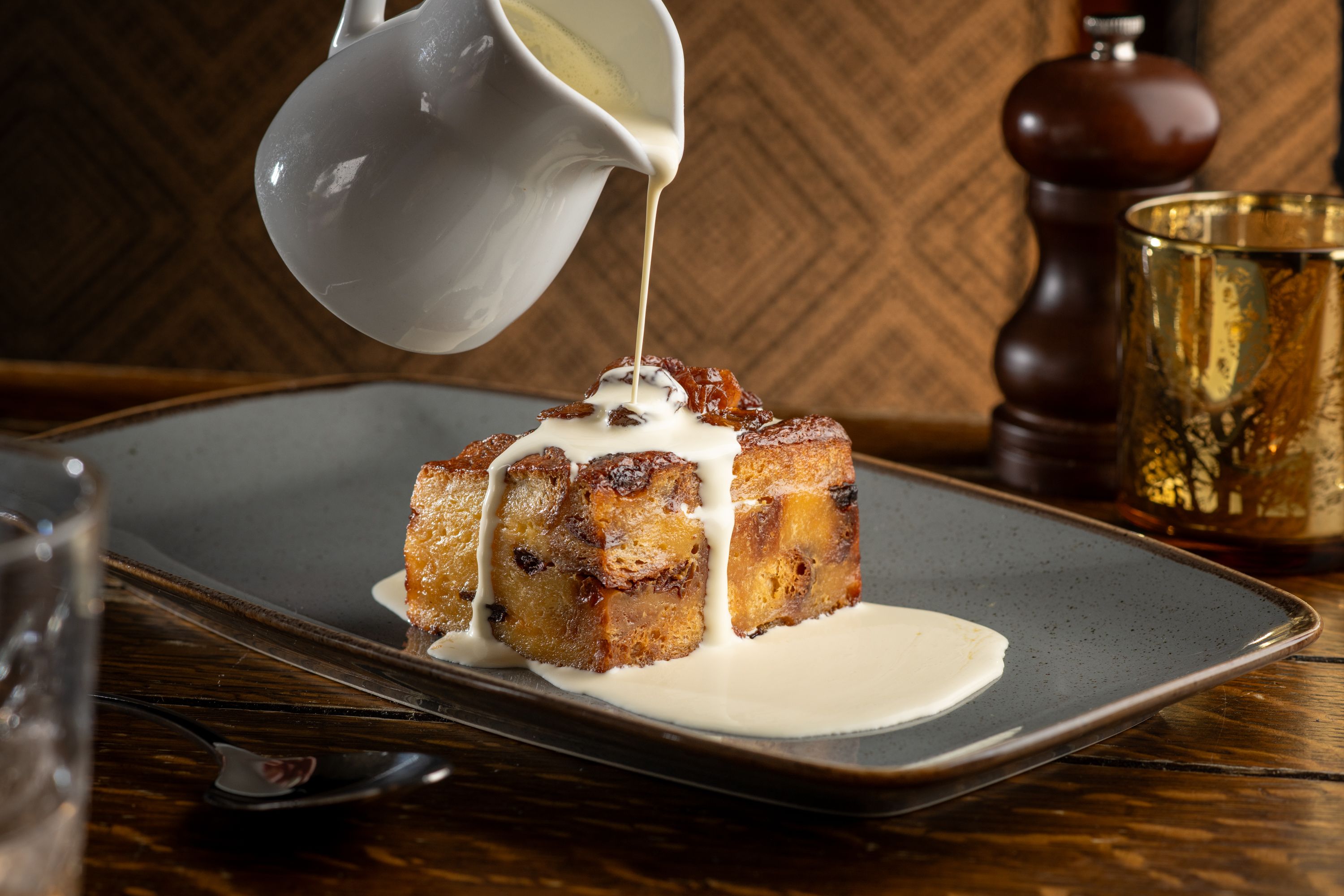 cream being poured on a dessert