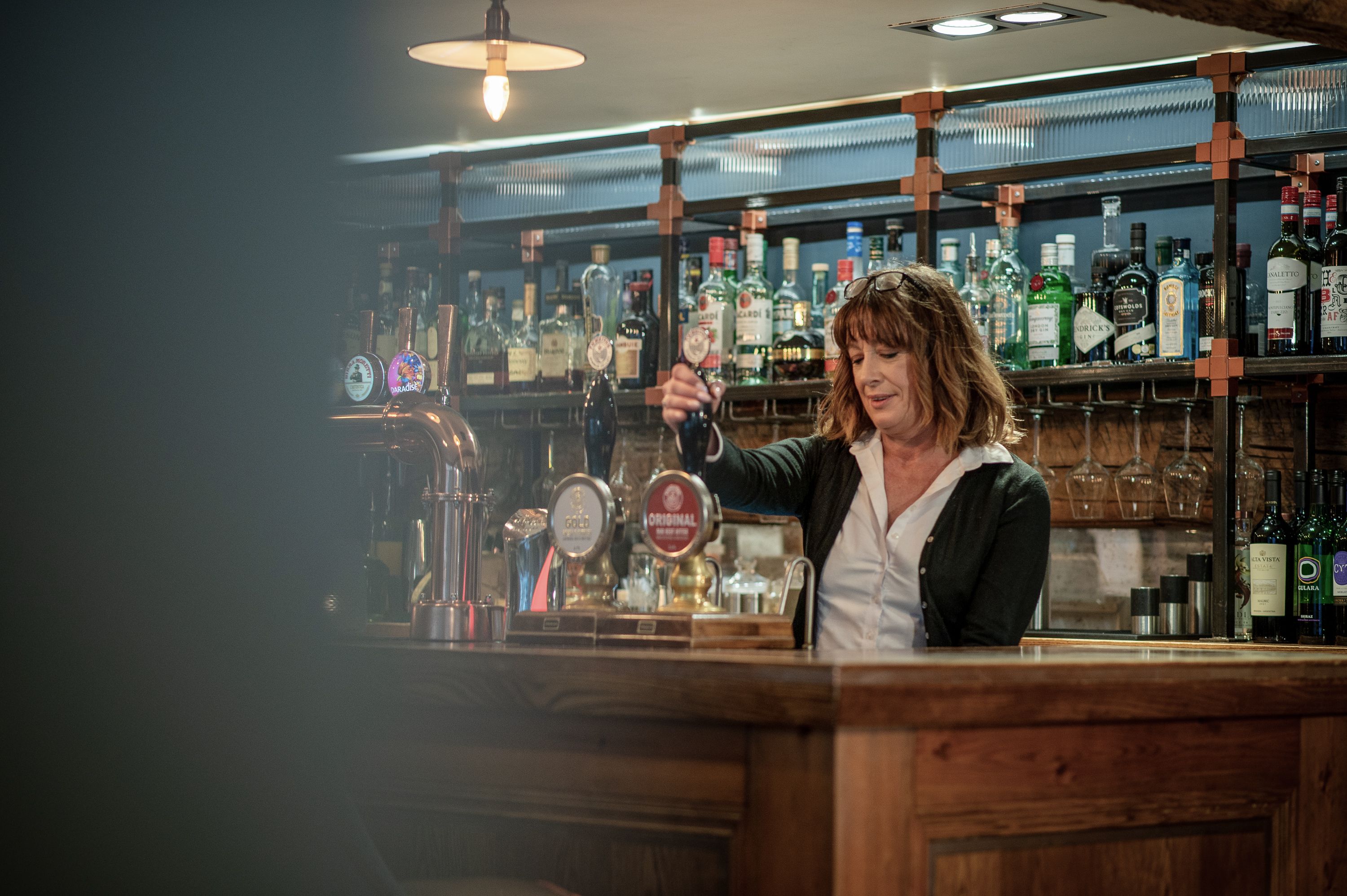 bar staff pouring a pint for a local