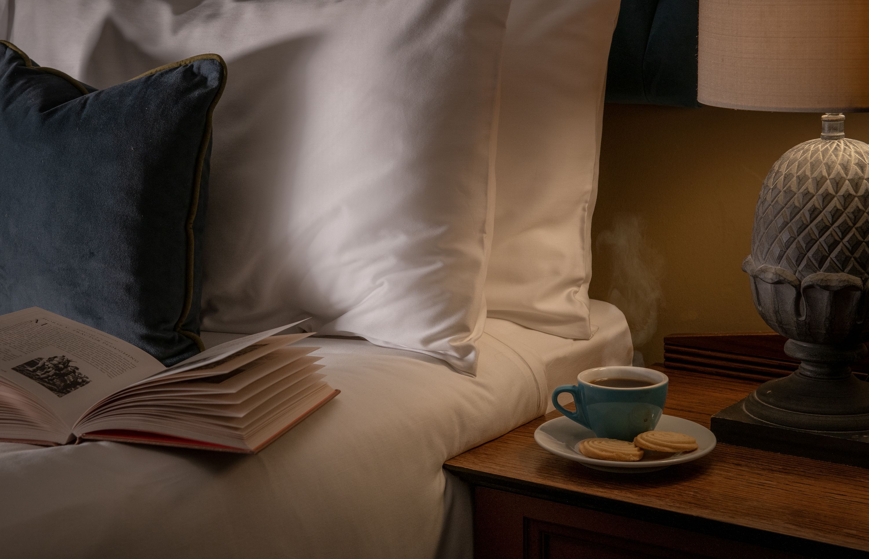 bed with book and coffee