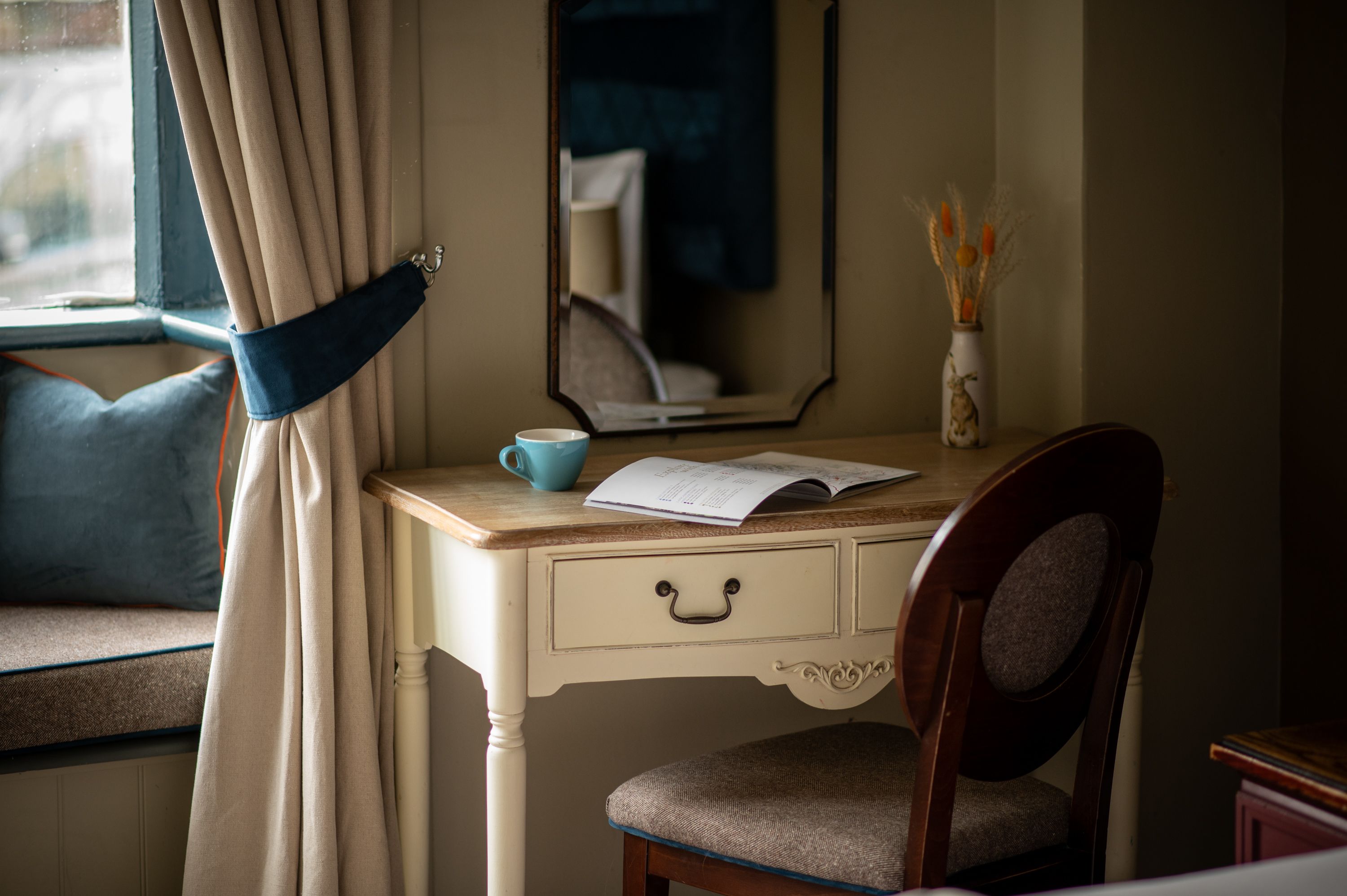 desk in a twin bedroom with magazine and coffee